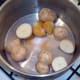 Potatoes are seasoned with salt, pepper and turmeric