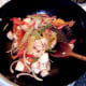 Chicken and vegetables are stir fried on a high heat