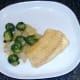 Cod, celtuce and sprouts are plated