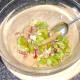 Salad ingredients are carefully stirred and combined