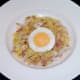 Fried egg is laid on top of fried rice