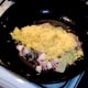 Cooled rice is added to wok