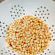 Remove the skins from the peanuts and dry-blend them.