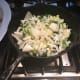 Adding together new vegetables and the wine.