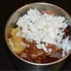 Put this mixture into a mixer jar. Add jaggery, grated coconut, soaked tamarind, and salt.