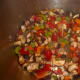Sauté all the veggies together, then add the browned beef cubes, stock, wine, and herbs.