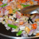 Step three: Add chopped onions, minced ginger, garlic, and slit green chilies. Saute till onions become transparent. Now, add chopped tomatoes. Throw in some salt.