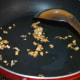 Step one: Heat olive oil. Add chopped garlic to it. Saute until they get brownish and crispy.