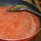 Step three: Add tomato puree. Add some salt. Increase the heat. Stir-cook until the mixture becomes thick.