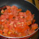 Step two: Add tomatoes. Throw in some salt. Stir-cook over medium high heat until tomatoes become mushy.