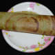 Step six: Place two teaspoons of the stuffing in the center. Roll the dosa along the stuffing. Serve hot pesarattu masala dosa with coconut chutney. Enjoy the taste.