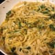 Skillet with white wine fettuccine, baby greens, and golden beets