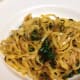 Fettuccine pasta cooked in white wine, with sauteed golden beets and greens