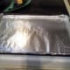 Step Seven: Line a cookie sheet with aluminum foil and spray it thoroughly with cooking spray.