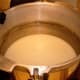 You will likely have milk overflow, because of the high-pressure boil. This is what the water in the canner looks like after the jars are processed. A few tablespoons were lost from 7 jars.