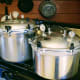 Each canner has been filled with 2 quarts of water. (Fill yours per the instructions which come with it.) The lids have been tightened down evenly, alternating opposite pairs of screws.