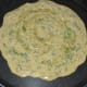 Step three: Pour a ladle full of the batter on a hot pan. Spread it a little. Add a few drops of oil on the top.