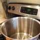 Clean your canner with soap and water, replace your jar rack, and half fill it with water.