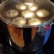 Top with a lid and crank the heat to high on the stove. When your pot starts to boil over, tilt the lid to release the extra steam, set your timer, and turn the heat down a notch or two. You want your water to boil vigorously throughout canning.