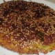 Step seven: Flip it now. Press it a little. Add a few drops of oil on the edges. Let the other side also become crispy and golden brown.