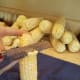 Set it up on end and run your knife along the side of the cob, cutting all of the kernels off.