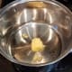 Melt some butter in a large pot on the stove over medium heat.