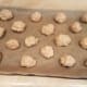 Roll biscuits sized balls together and lay them out evenly on your cookie sheet. We smashed them down a bit.