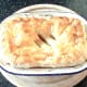Cooked pie is removed from the oven and left to rest