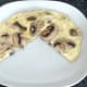 Garlic mushrooms tortilla is sliced in half and plated