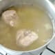 Chicken thighs are left to part cool in stock