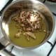 Chopped mushroom stems and garlic are started sauteing