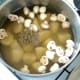 Mushrooms and potatoes are added to strained stock