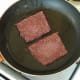 Sausages are turned to fry on second sides