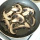 Mushrooms are turned to fry on their second side