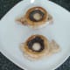 Mushroom cups are laid on pork fillets