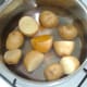 Salt and turmeric are added to prepared potatoes