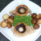 Deep fried potatoes and peas are arranged on serving plate