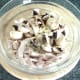 Chicken thigh meat, mushrooms, garlic and seasonings are combined in a bowl