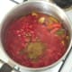 Tomatoes and seasonings are added to softened vegetables