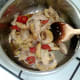 Mushrooms and chicken meat are added to cooked down tomatoes