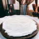 Frosting the first layer of the cake.
