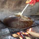 The water evaporates, and the cream separates from the oil. Time to remove the oil from the pan, as it is turning brown.