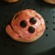 Adorable jack-o-lantern cinnamon roll.