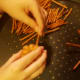 Carefully push pretzel sticks into donut. Eight per donut.