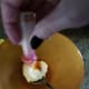 Simply use food coloring to turn your icing orange. Spread on cinnamon roll to create jack-o-lantern cinnamon rolls.