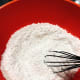 Use a whisk to mix the dry ingredients in the bowl.