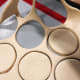 Roll the dough onto a baking mat. Shape the donuts with a donut cutter.