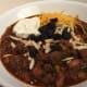 Fruit and Nut Chili with raisins, almonds, cheese, and sour cream