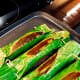 Cook each side for five minutes or more. I like the banana leaves to get a bit scorched.