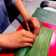 Tightly roll the banana leaf from the bottom.